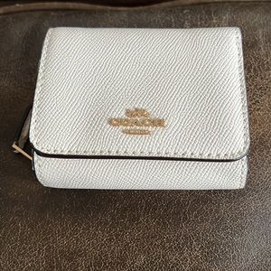 White leather coach wallet.